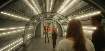 Movie still from “Another Life” (2019), created by Aaron Martin – A man and a woman are walking through a tunnel; Wide shot, Low angle