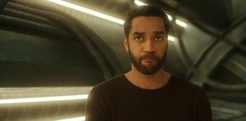 Movie still from “Another Life” (2019), created by Aaron Martin – A man with a goatee and a beard; Close Up shot, Low angle