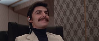 Movie still from “Westworld” (1973), directed by Michael Crichton – A man with a mustache wearing a jacket and a black turtleneck; Close Up shot, Low angle