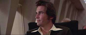 Movie still from “Westworld” (1973), directed by Michael Crichton – A person sitting in a chair; Close Up shot, Low angle