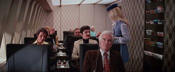 Movie still from “Westworld” (1973), directed by Michael Crichton – A group of people sitting in chairs in a room; Wide shot, Over the shoulder angle