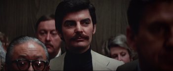 Movie still from “Westworld” (1973), directed by Michael Crichton – A man with a mustache in a suit; Close Up shot, Low angle