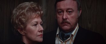 Movie still from “Westworld” (1973), directed by Michael Crichton – An older man and a younger woman looking at the camera; Close Up shot, Low angle