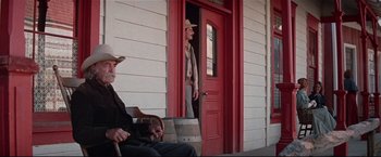 Movie still from “Westworld” (1973), directed by Michael Crichton – A man in a cowboy hat standing in front of a red door; Wide shot, Low angle