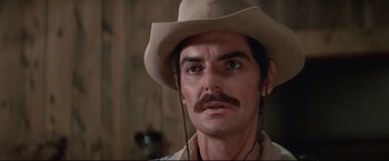 Movie still from “Westworld” (1973), directed by Michael Crichton – A person wearing a cowboy hat; Close Up shot, Low angle