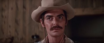 Movie still from “Westworld” (1973), directed by Michael Crichton – A person wearing a cowboy hat; Close Up shot, Low angle