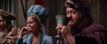 Movie still from “Westworld” (1973), directed by Michael Crichton – A man and a woman in medieval garb drinking from a cup; Close Up shot, Low angle
