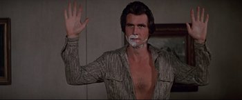 Movie still from “Westworld” (1973), directed by Michael Crichton – A man with a shaving foam on his face; Medium shot, Over the shoulder angle