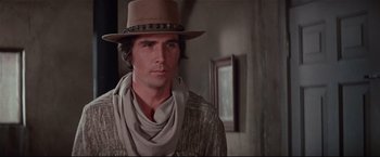Movie still from “Westworld” (1973), directed by Michael Crichton – A man wearing a cowboy hat and a scarf; Close Up shot, Low angle