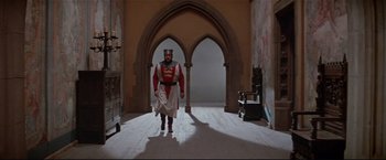 Movie still from “Westworld” (1973), directed by Michael Crichton – A man dressed as a knight stands in an archway; Wide shot, Low angle