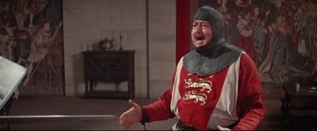 Movie still from “Westworld” (1973), directed by Michael Crichton – A man in a red and white suit with a dragon on his head; Medium shot, Over the shoulder angle