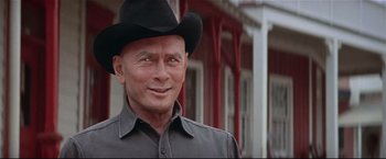 Movie still from “Westworld” (1973), directed by Michael Crichton – An older man wearing a black cowboy hat; Close Up shot, Over the shoulder angle