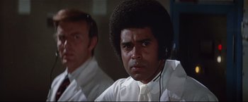 Movie still from “Westworld” (1973), directed by Michael Crichton – A man in a white shirt and a man in a white tie; Close Up shot, Low angle