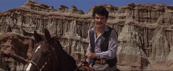 Movie still from “Westworld” (1973), directed by Michael Crichton – A man on a horse in front of a mountain; Medium shot, Low angle