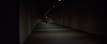 Movie still from “Westworld” (1973), directed by Michael Crichton – A man walking down a dark hallway in the dark; Extreme Wide shot, High angle