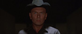 Movie still from “Westworld” (1973), directed by Michael Crichton – A person wearing a cowboy hat; Close Up shot, Low angle