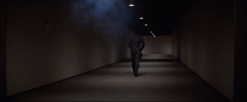 Movie still from “Westworld” (1973), directed by Michael Crichton – A man walking down a hallway with smoke coming out of the ceiling; Wide shot, Low angle