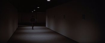 Movie still from “Westworld” (1973), directed by Michael Crichton – A man is walking in a dark hallway; Wide shot, High angle