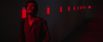 Movie still from “Westworld” (1973), directed by Michael Crichton – A man standing in front of a wall with red lights on it; Medium shot, Low angle