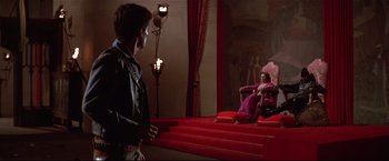 Movie still from “Westworld” (1973), directed by Michael Crichton – A man and a woman sitting on the steps of a staircase; Wide shot, Over the shoulder angle