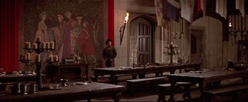 Movie still from “Westworld” (1973), directed by Michael Crichton – A man standing in front of a table in a room; Wide shot, High angle