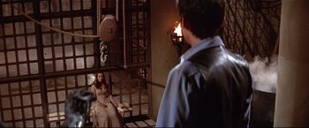 Movie still from “Westworld” (1973), directed by Michael Crichton – A man and a woman are in a jail cell; Wide shot, High angle