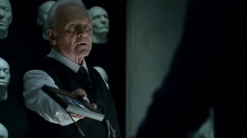 Movie still from “Westworld” (2016), created by Lisa Joy – A man in a suit and tie holding a book; Close Up shot, Over the shoulder angle