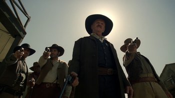 Movie still from “Westworld” (2016), created by Lisa Joy – A group of men standing next to each other in a field; Medium shot, Low angle