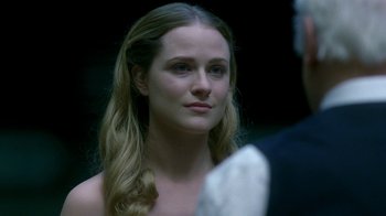 Movie still from “Westworld” (2016), created by Lisa Joy – A woman with long blonde hair looking at the camera; Close Up shot, Over the shoulder angle