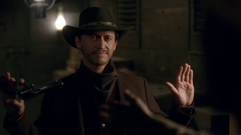 Movie still from “Westworld” (2016), created by Lisa Joy – A man wearing a hat and a suit; Close Up shot, Over the shoulder angle