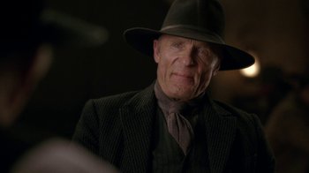 Movie still from “Westworld” (2016), created by Lisa Joy – An older man wearing a hat and a suit; Close Up shot, Over the shoulder angle