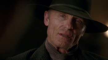 Movie still from “Westworld” (2016), created by Lisa Joy – An older man wearing a hat and a suit; Close Up shot, Low angle