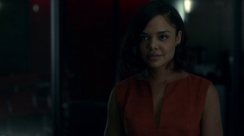 Movie still from “Westworld” (2016), created by Lisa Joy – A woman in a red dress is standing in a dark room; Close Up shot, Over the shoulder angle