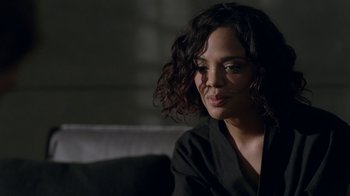 Movie still from “Westworld” (2016), created by Lisa Joy – A woman sitting on top of a couch in a room; Close Up shot, Over the shoulder angle