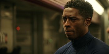 Movie still from “Another Life” (2019), created by Aaron Martin – A person wearing a jacket; Close Up shot, Low angle