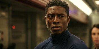 Movie still from “Another Life” (2019), created by Aaron Martin – A person wearing a jacket; Close Up shot, Low angle