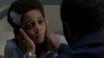 Movie still from “Westworld” (2016), created by Lisa Joy – A young boy with his hands under his chin; Close Up shot, Over the shoulder angle