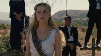 Movie still from “Westworld” (2016), created by Lisa Joy – A woman in a white dress with a gun in her mouth; Close Up shot, Over the shoulder angle