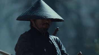 Movie still from “Westworld” (2016), created by Lisa Joy – A man wearing a hat and holding a stick; Close Up shot, Low angle