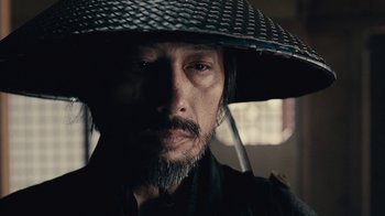 Movie still from “Westworld” (2016), created by Lisa Joy – A person wearing a hat; Close Up shot, Over the shoulder angle