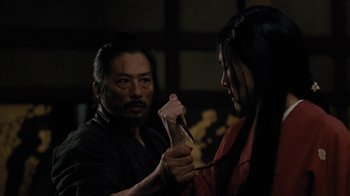 Movie still from “Westworld” (2016), created by Lisa Joy – A man and a woman are holding a knife; Close Up shot, Over the shoulder angle