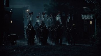 Movie still from “Westworld” (2016), created by Lisa Joy – A group of people in medieval garb marching down a street; Wide shot, Low angle