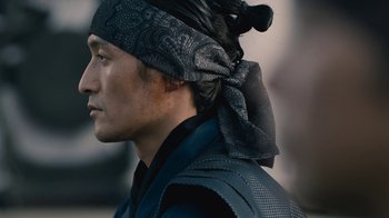 Movie still from “Westworld” (2016), created by Lisa Joy – A person wearing a head scarf; Close Up shot, Low angle