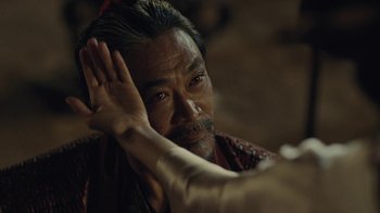 Movie still from “Westworld” (2016), created by Lisa Joy – An older man with long black hair and a beard; Close Up shot, Over the shoulder angle