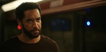 Movie still from “Another Life” (2019), created by Aaron Martin – A person wearing a brown shirt; Close Up shot, Low angle