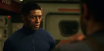 Movie still from “Another Life” (2019), created by Aaron Martin – A person wearing a blue jacket; Close Up shot, Over the shoulder angle