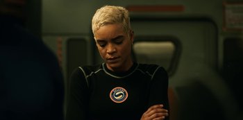 Movie still from “Another Life” (2019), created by Aaron Martin – A woman with blonde hair is looking down at her shoulder; Close Up shot, High angle