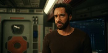 Movie still from “Another Life” (2019), created by Aaron Martin – A person wearing a brown shirt; Close Up shot, Low angle