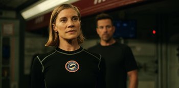 Movie still from “Another Life” (2019), created by Aaron Martin – A man and a woman wearing black shirts; Medium shot, Over the shoulder angle