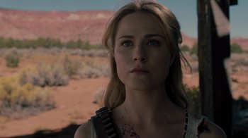 Movie still from “Westworld” (2016), created by Lisa Joy – A beautiful woman with a gun in her mouth; Close Up shot, Over the shoulder angle